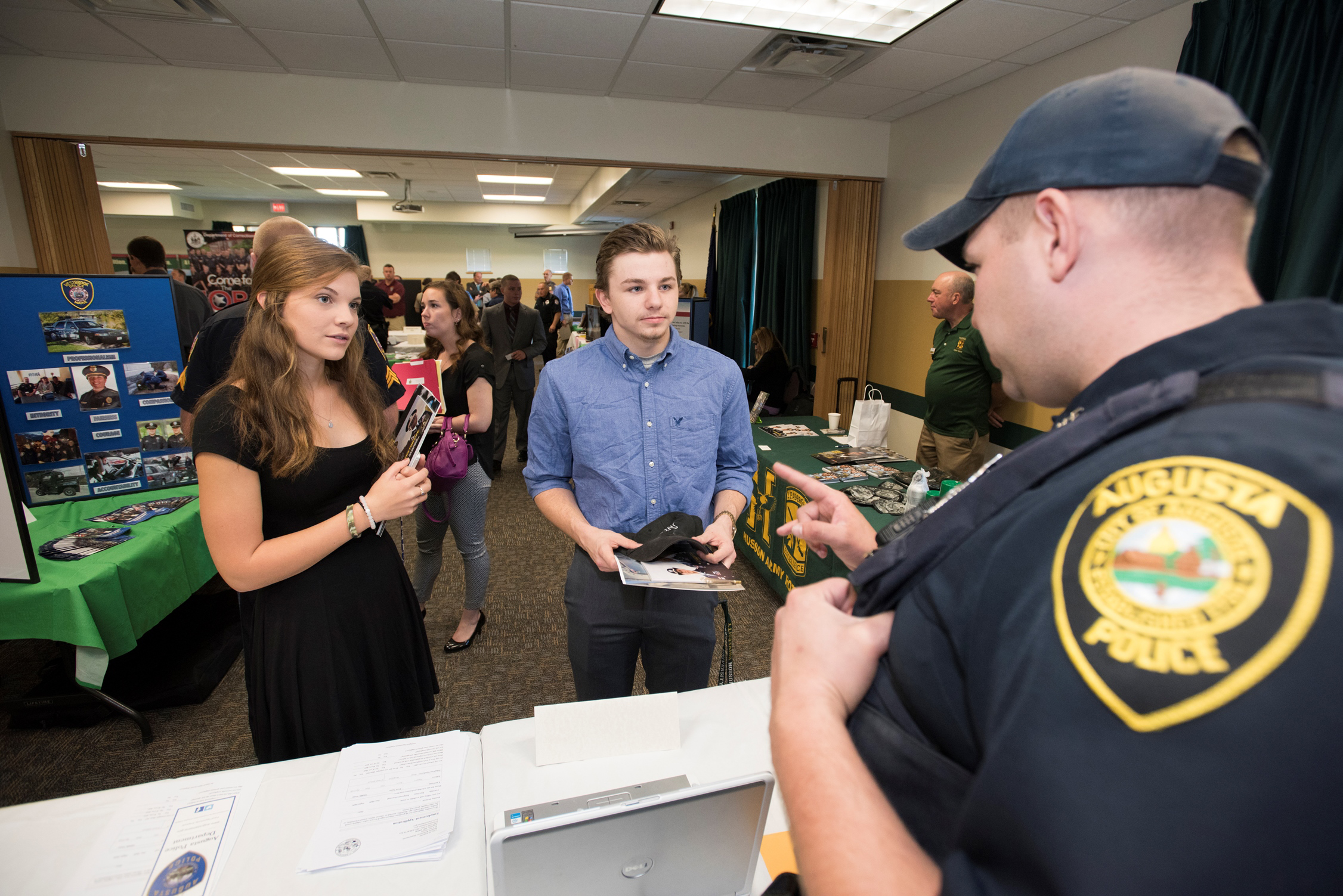 A female and male student speak with a potential employer.