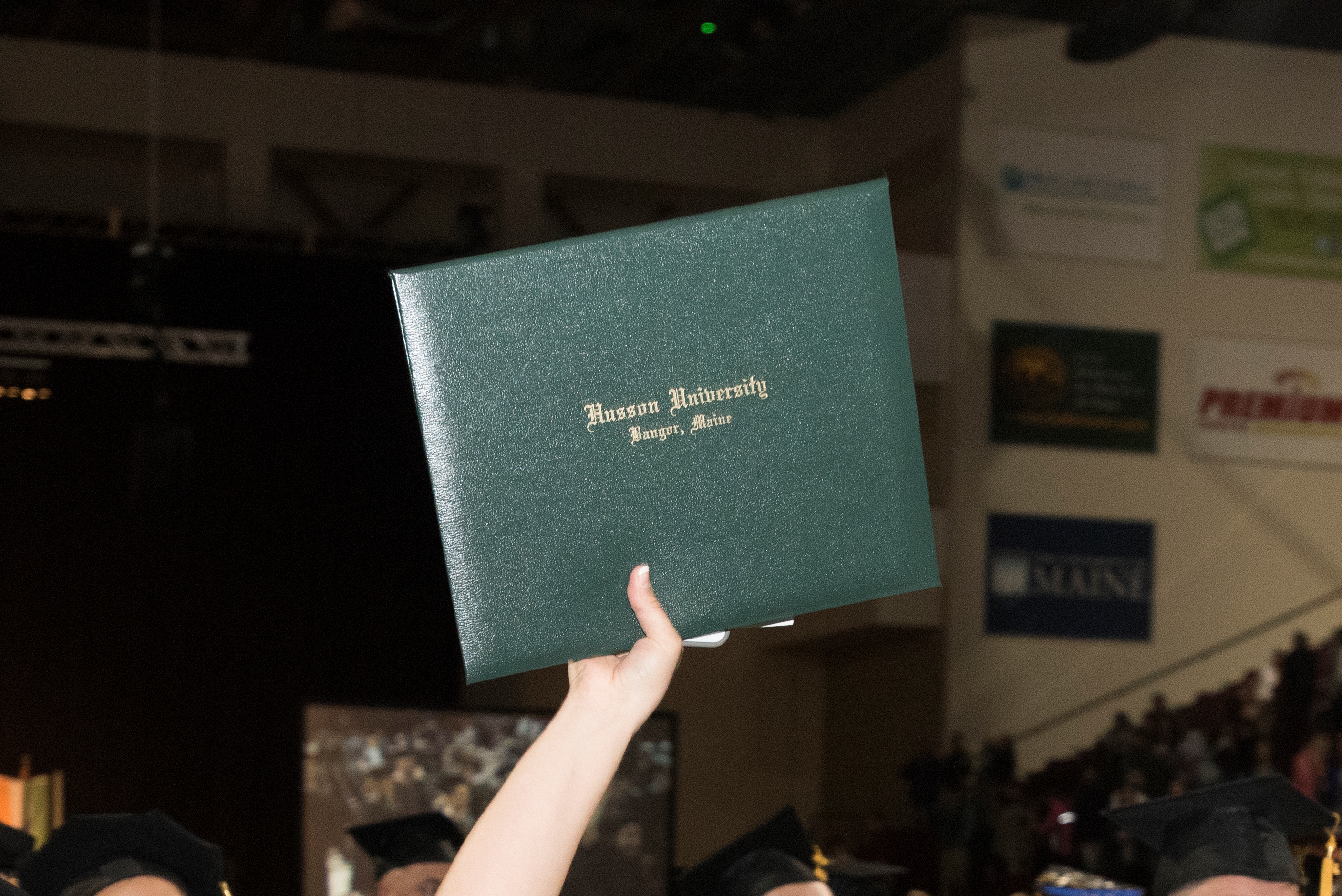diploma being held up during commencement