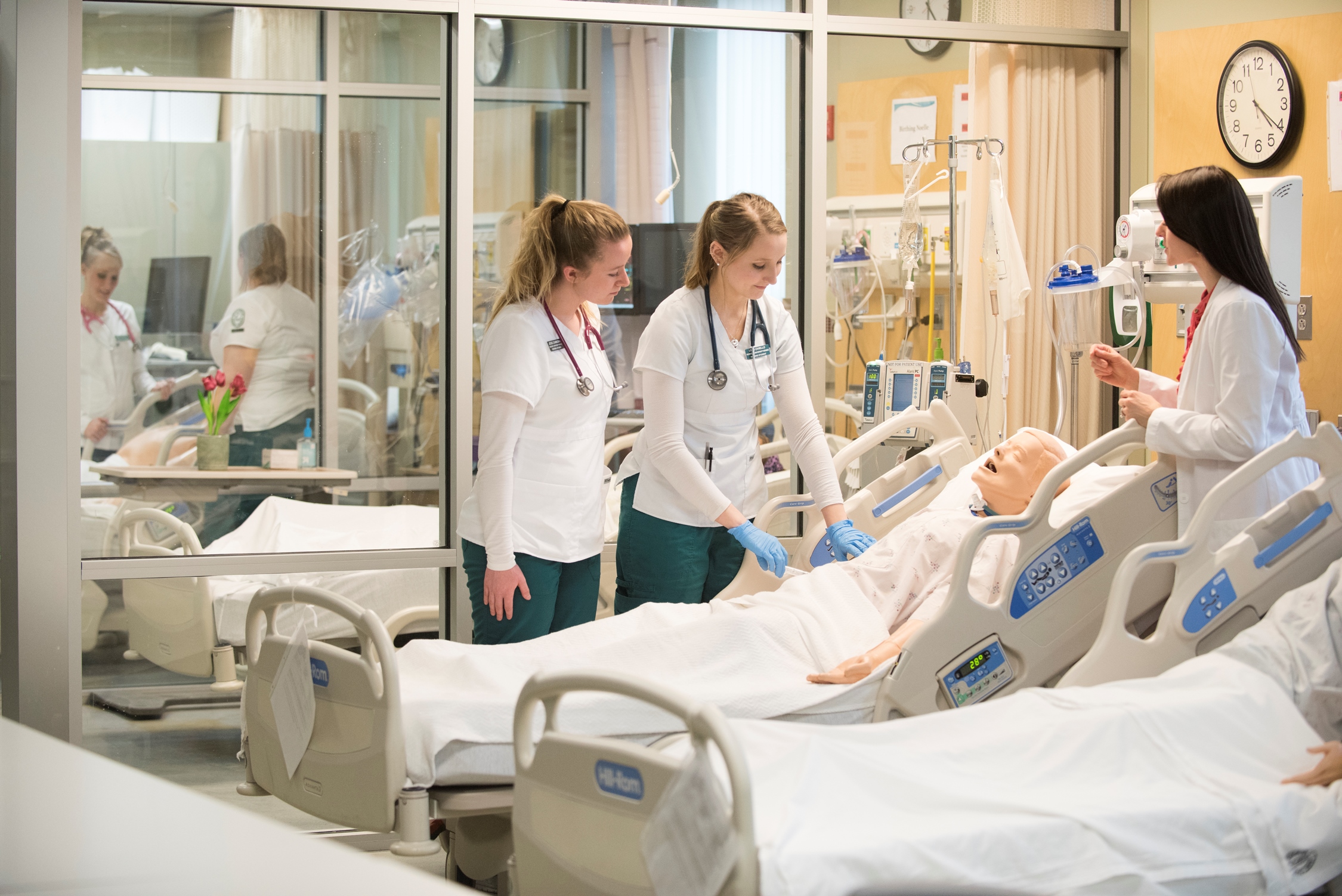 Students working in Nursing Simulation lab with staff