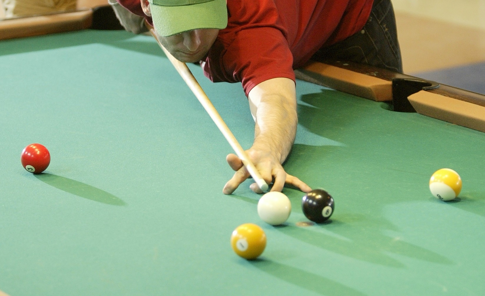 young man enjoying a game of billiards