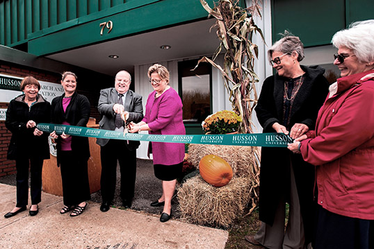 Faculty and Staff participate in a ribbon cutting ceremony