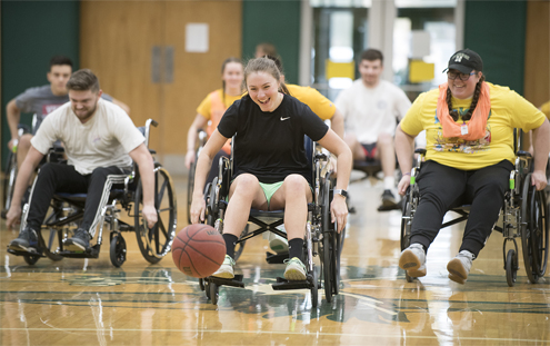 Students participate in wheelchair basketball