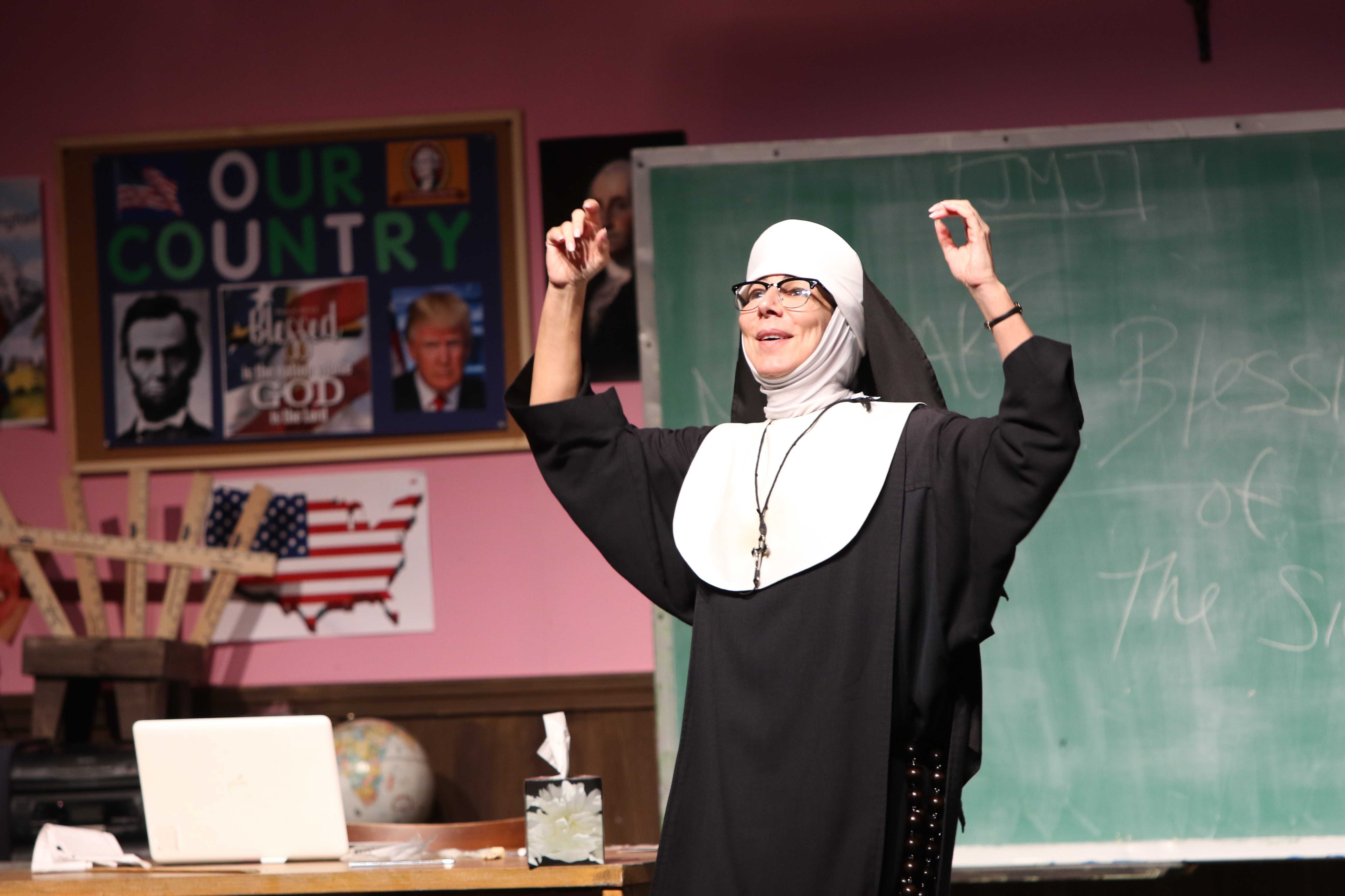 Nun dressed in a habit raises her arms