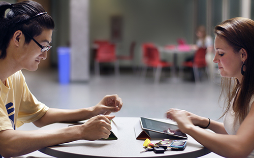 Students learning online with tablets