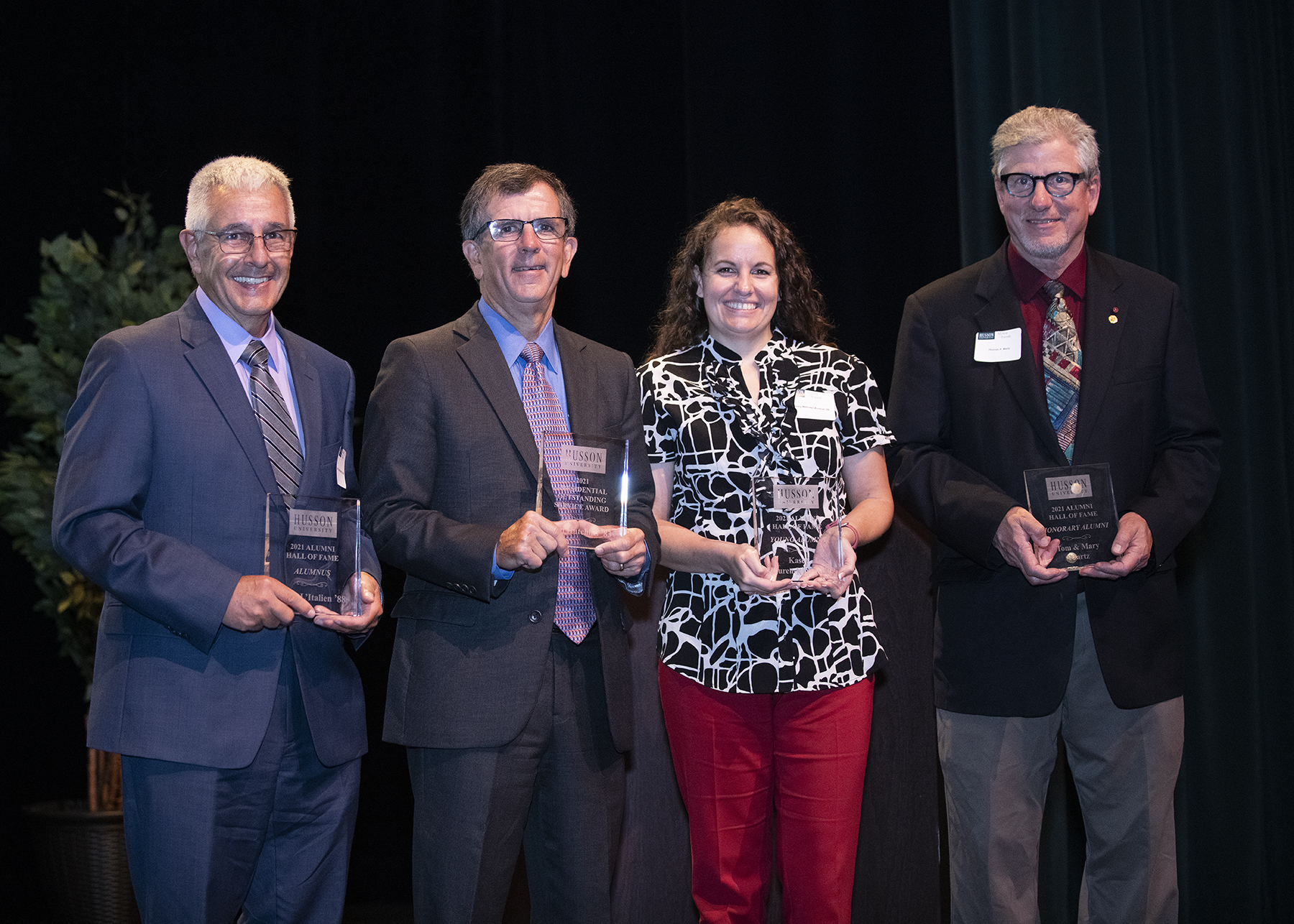 four people pose with their awards