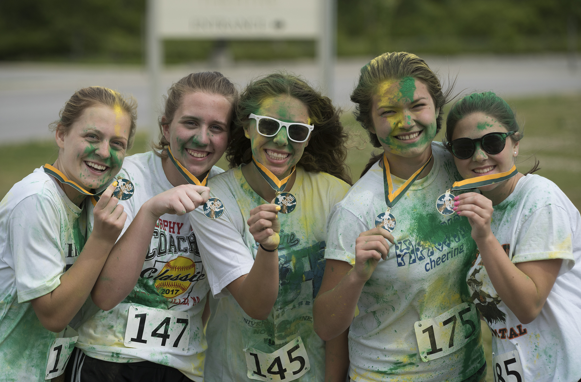 five students hold up medals