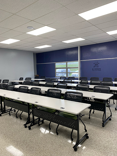 Rows of desks and chairs inside a classroom