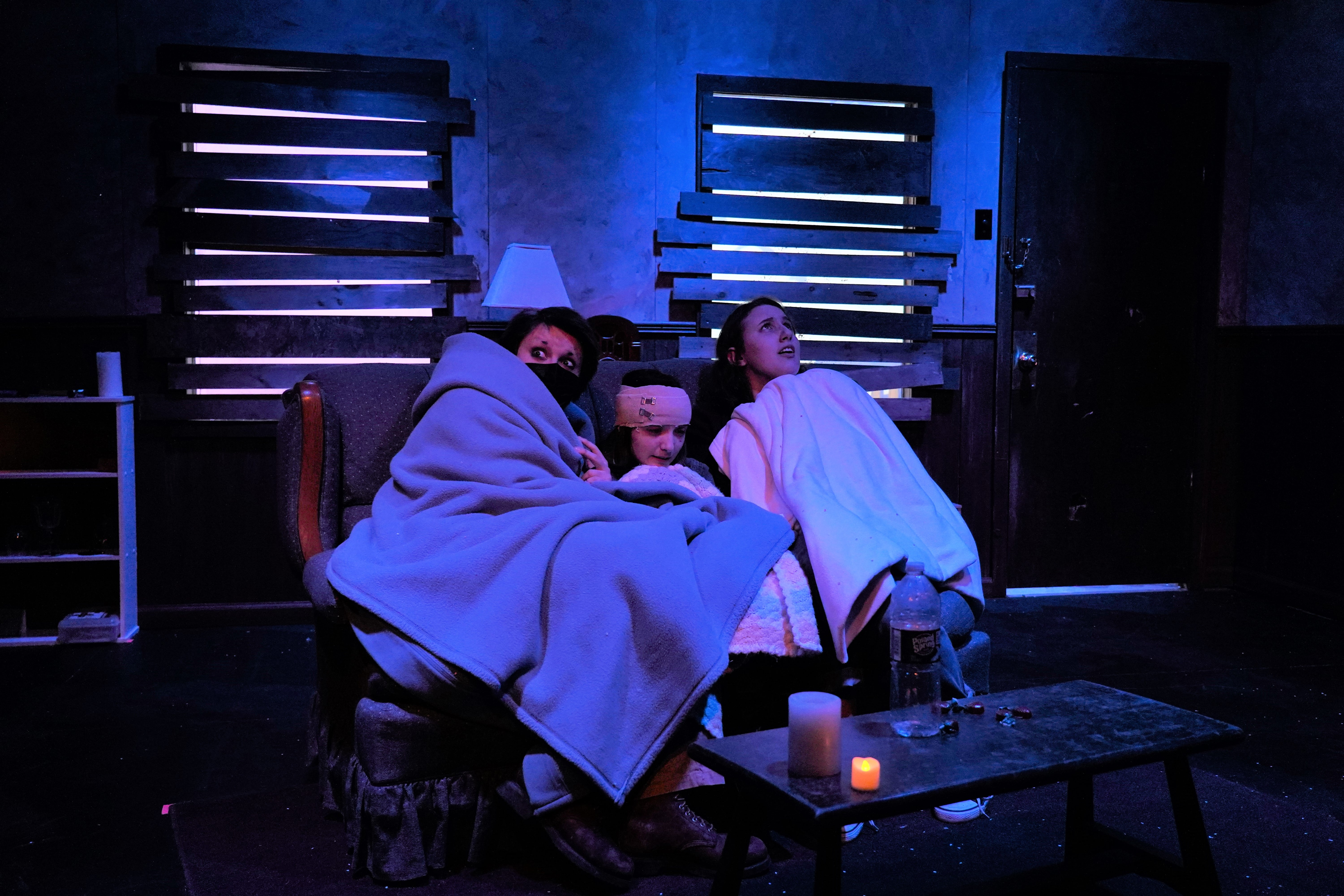 three people sitting on a couch