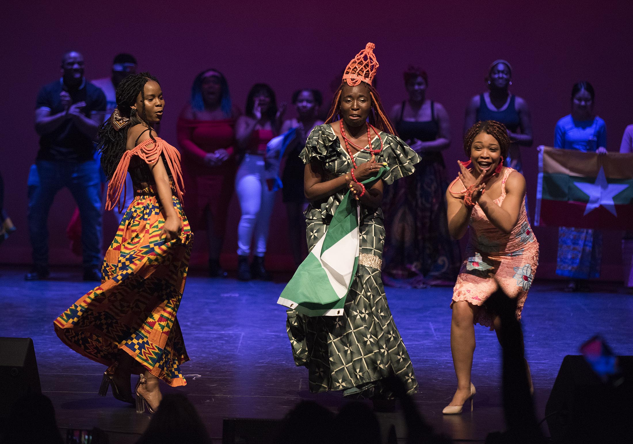 three people dancing on a stage