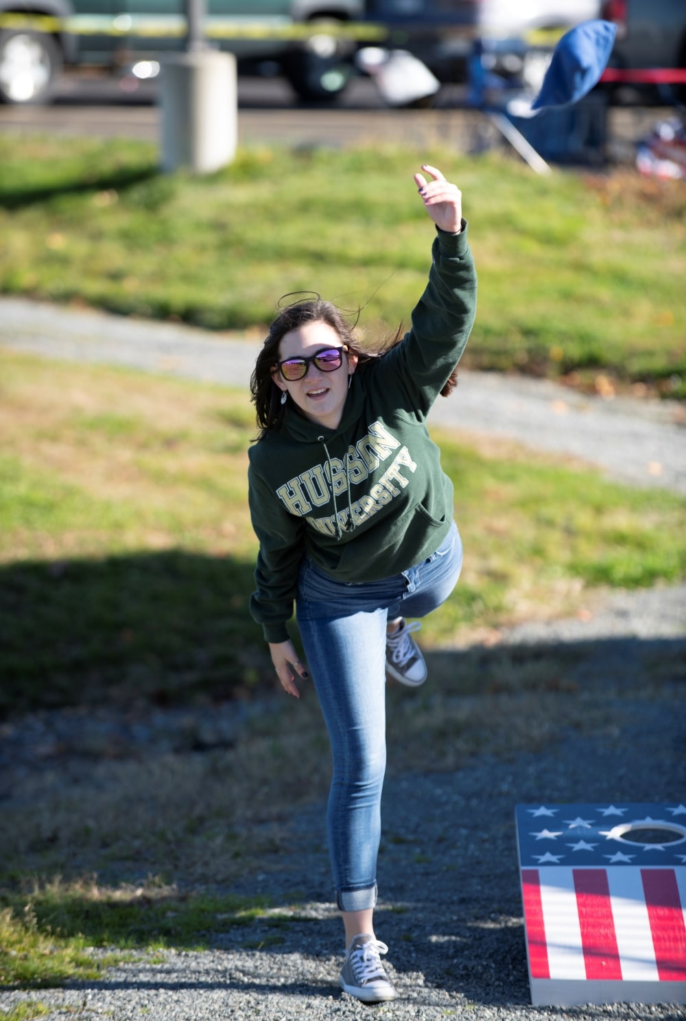 student tossing a small bean bag