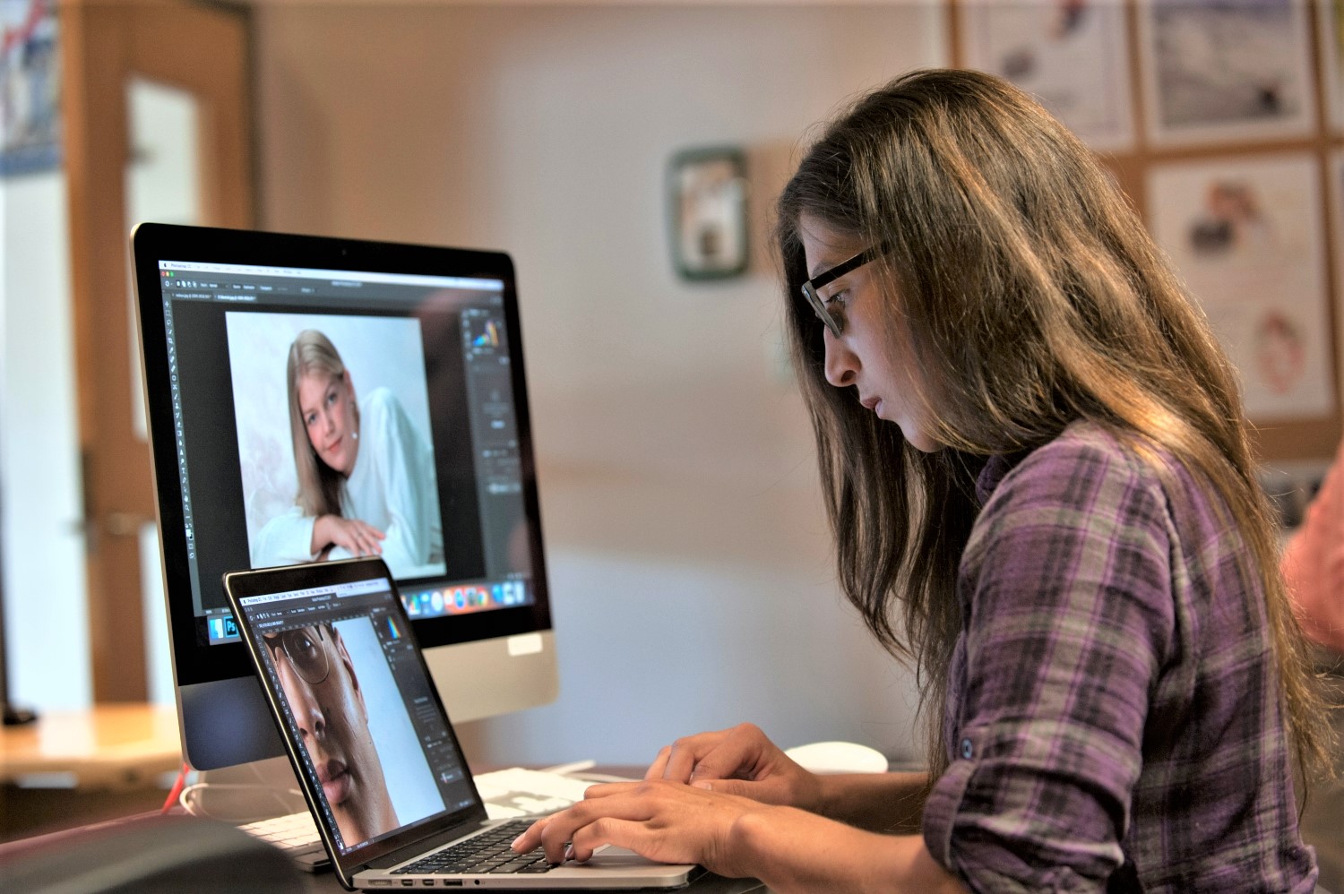 woman editing an image on a laptop computer