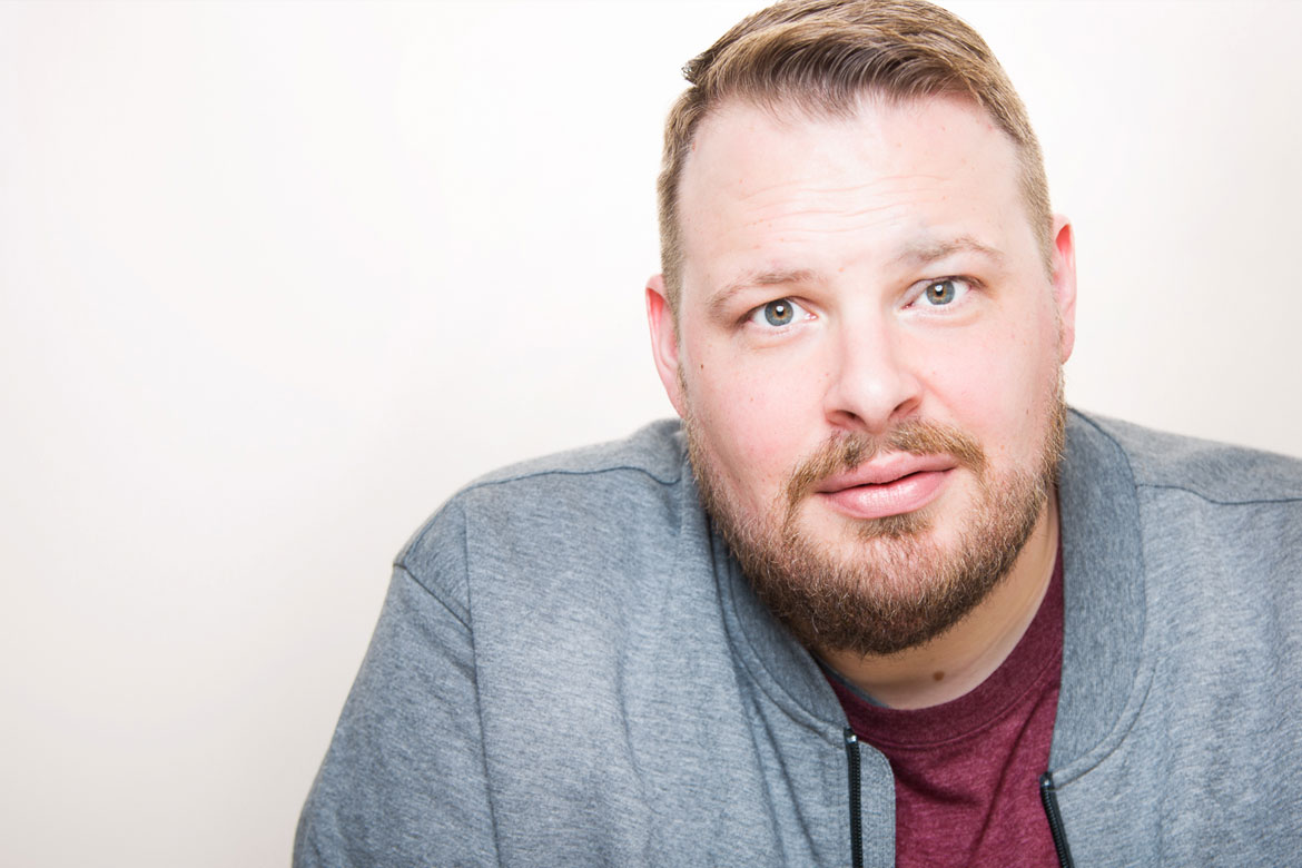 ray harrington posing in front of a white background