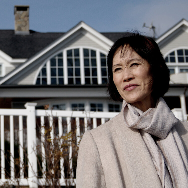 Tess Gerritsen posing in front of a house