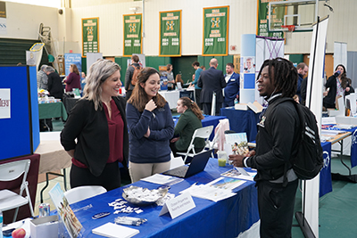 Student talking to representative at career fair