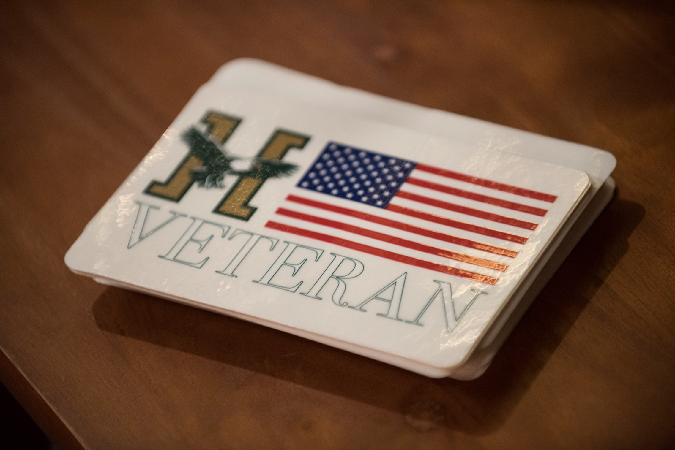 A name tag with the Husson logo, an American flag and the word 'veteran' on it.