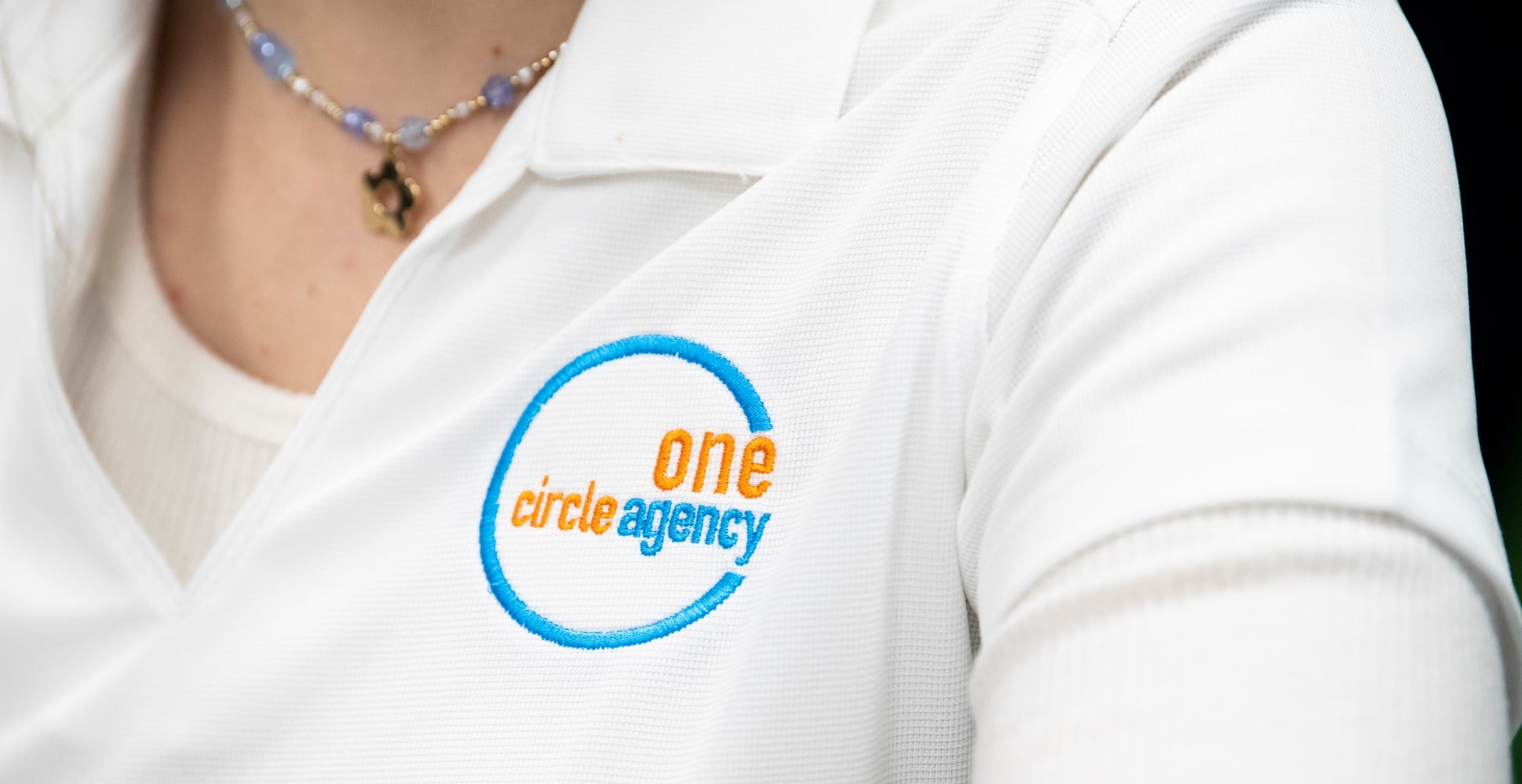 The One Circle Agency logo shown on a white shirt.