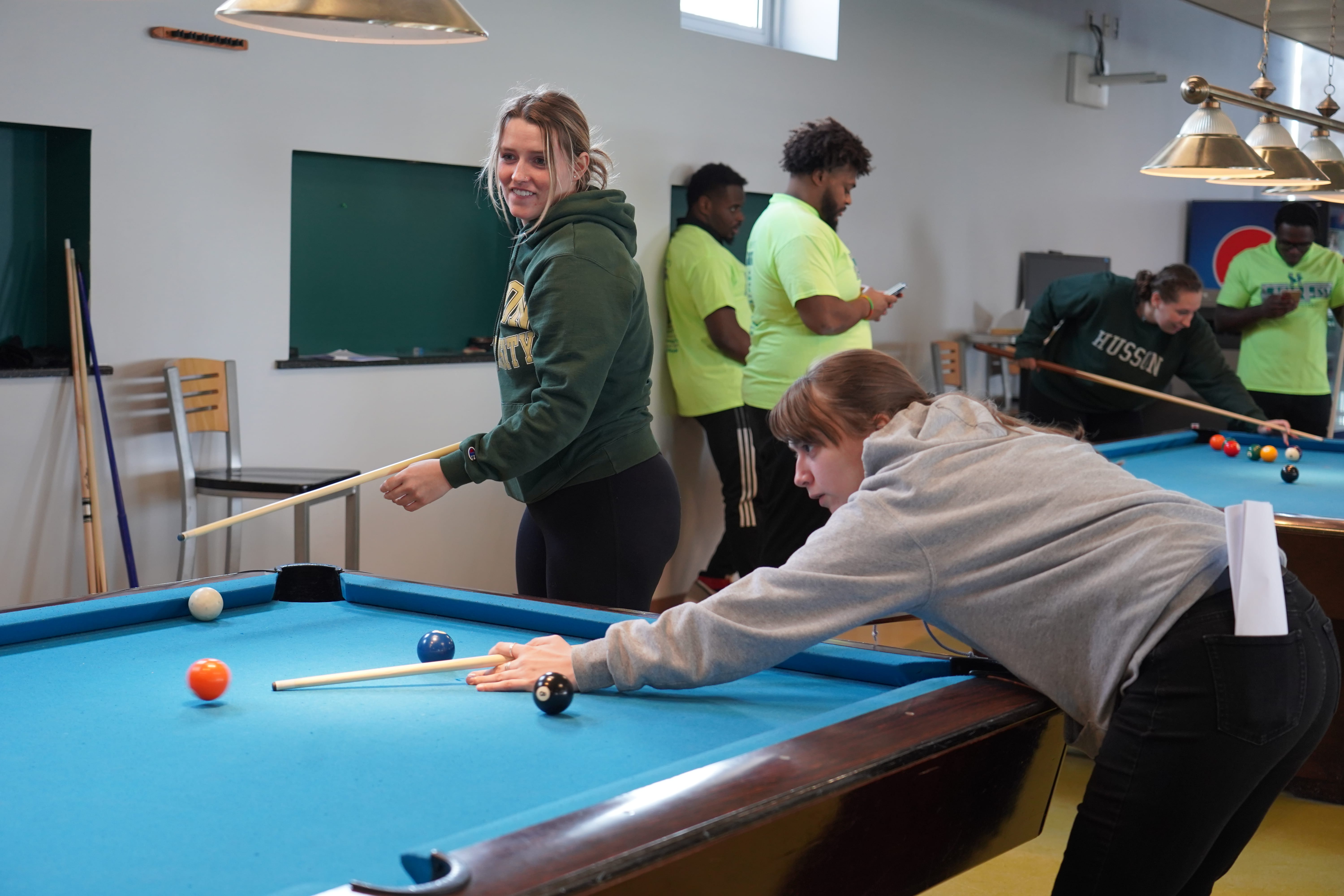Two students playing pool