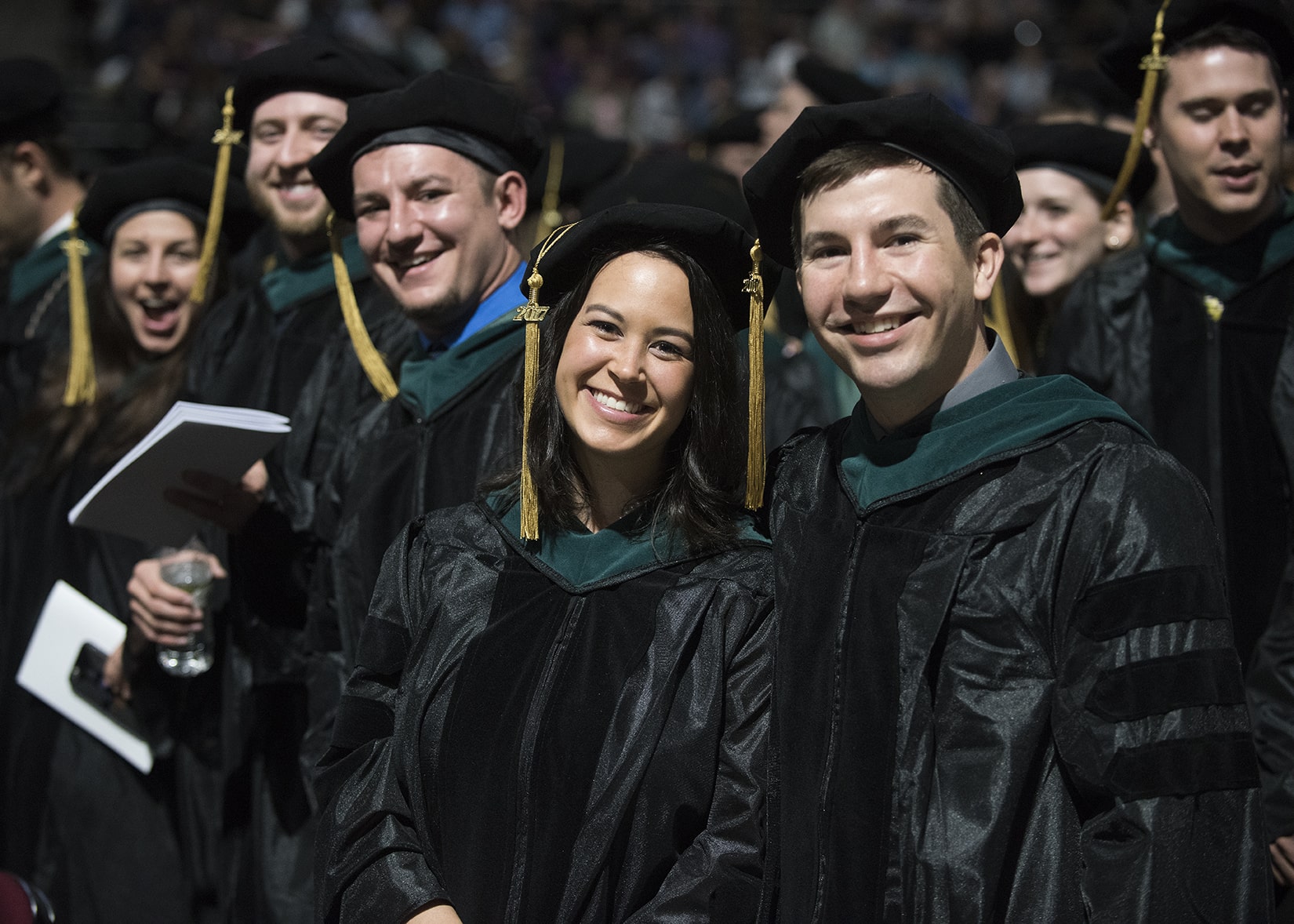 Students posing together at a graduation ceremony.