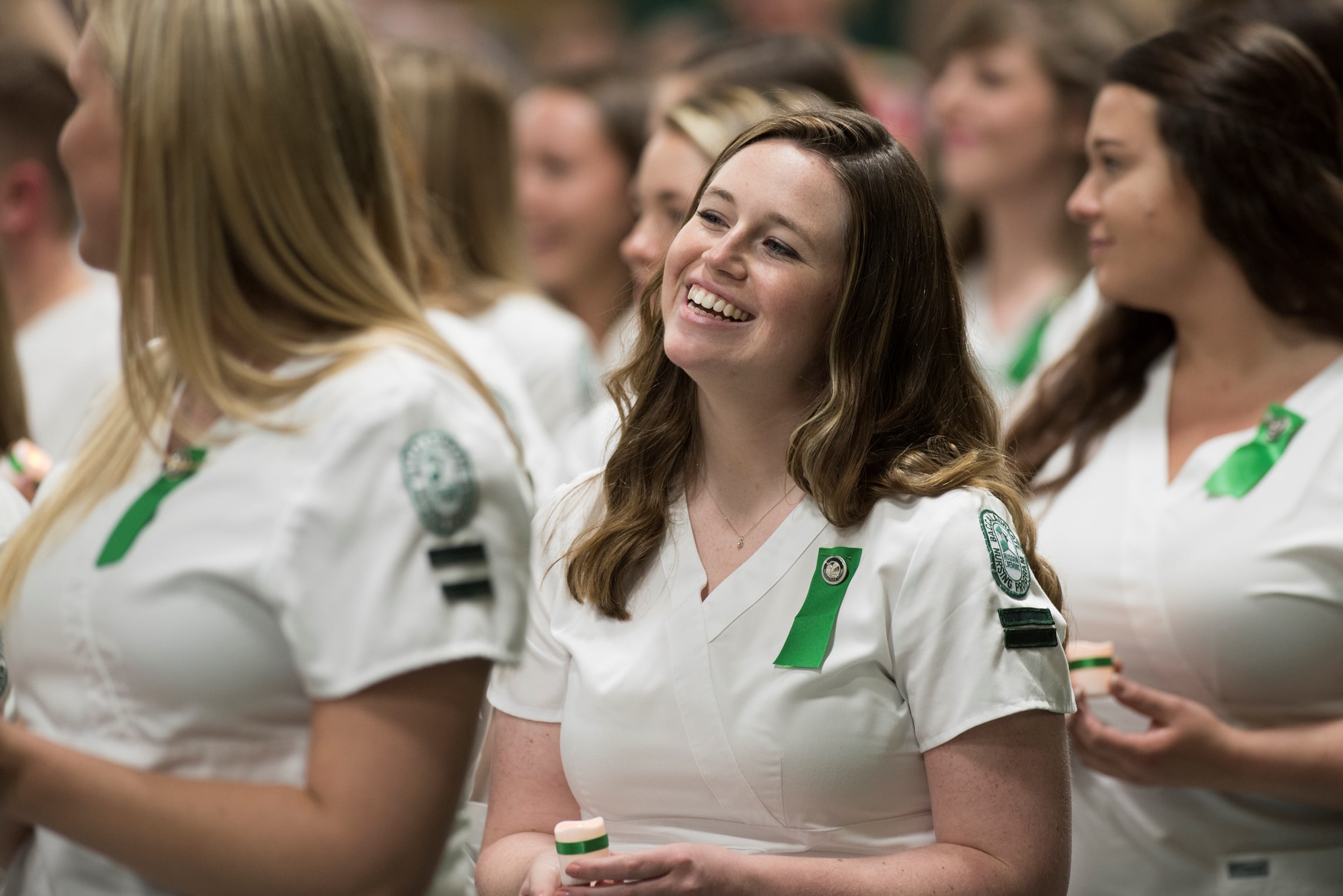 Nurses smiling after receiving their pins during the School of Nursing pinning ceremony.