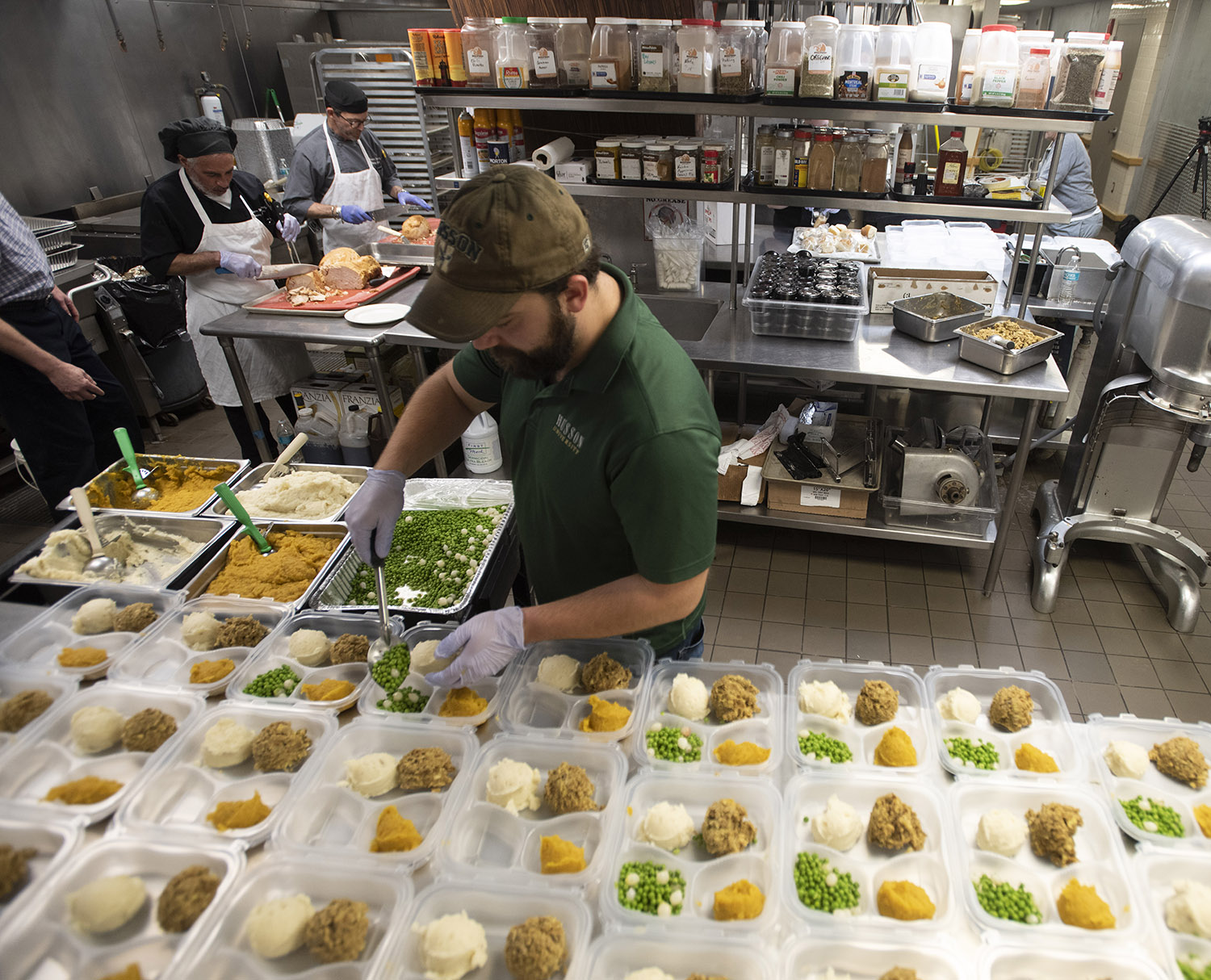 Volunteers are shown in the Dickerman Dining Center preparing meals in 2022 for Thanksgiving.