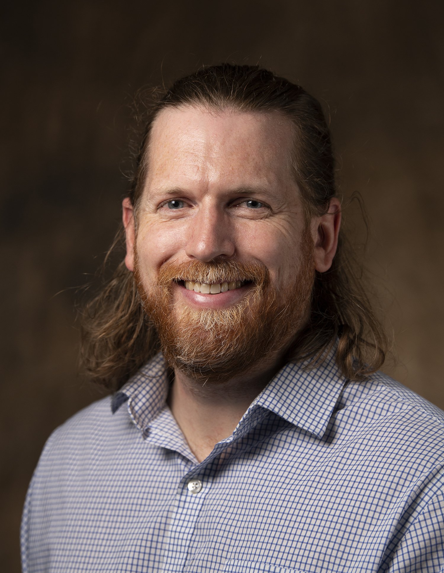 This is a headshot of a smiling man.