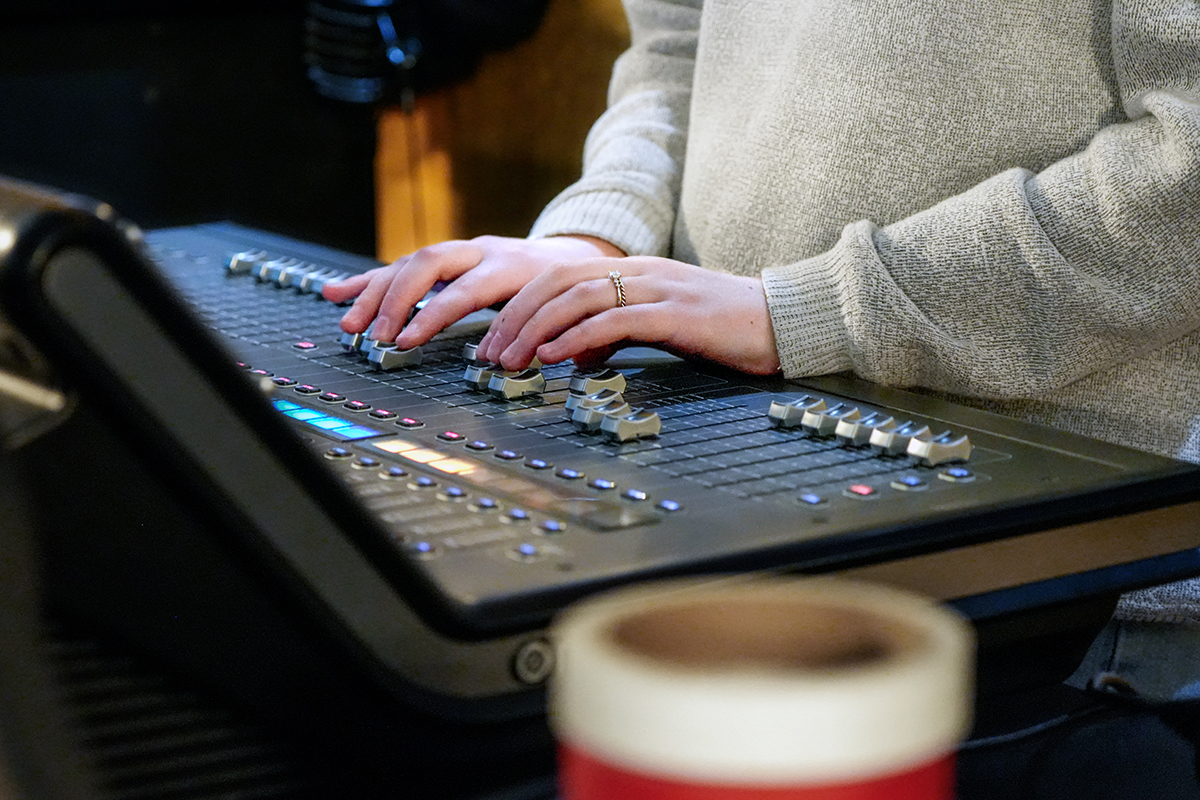 This is a close up of hands on a board with sliding adjusters.