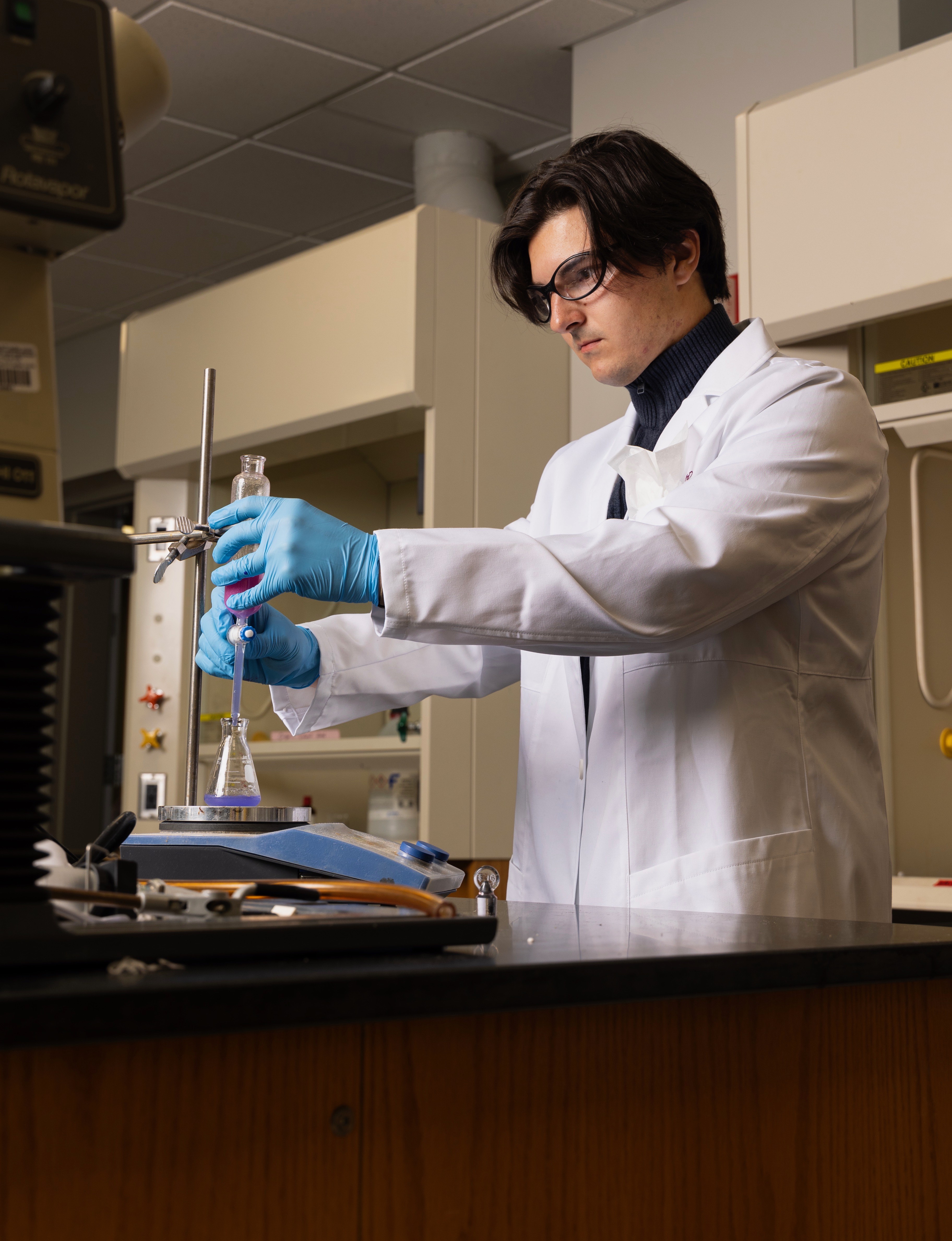 A man in a white lab coat is shown.