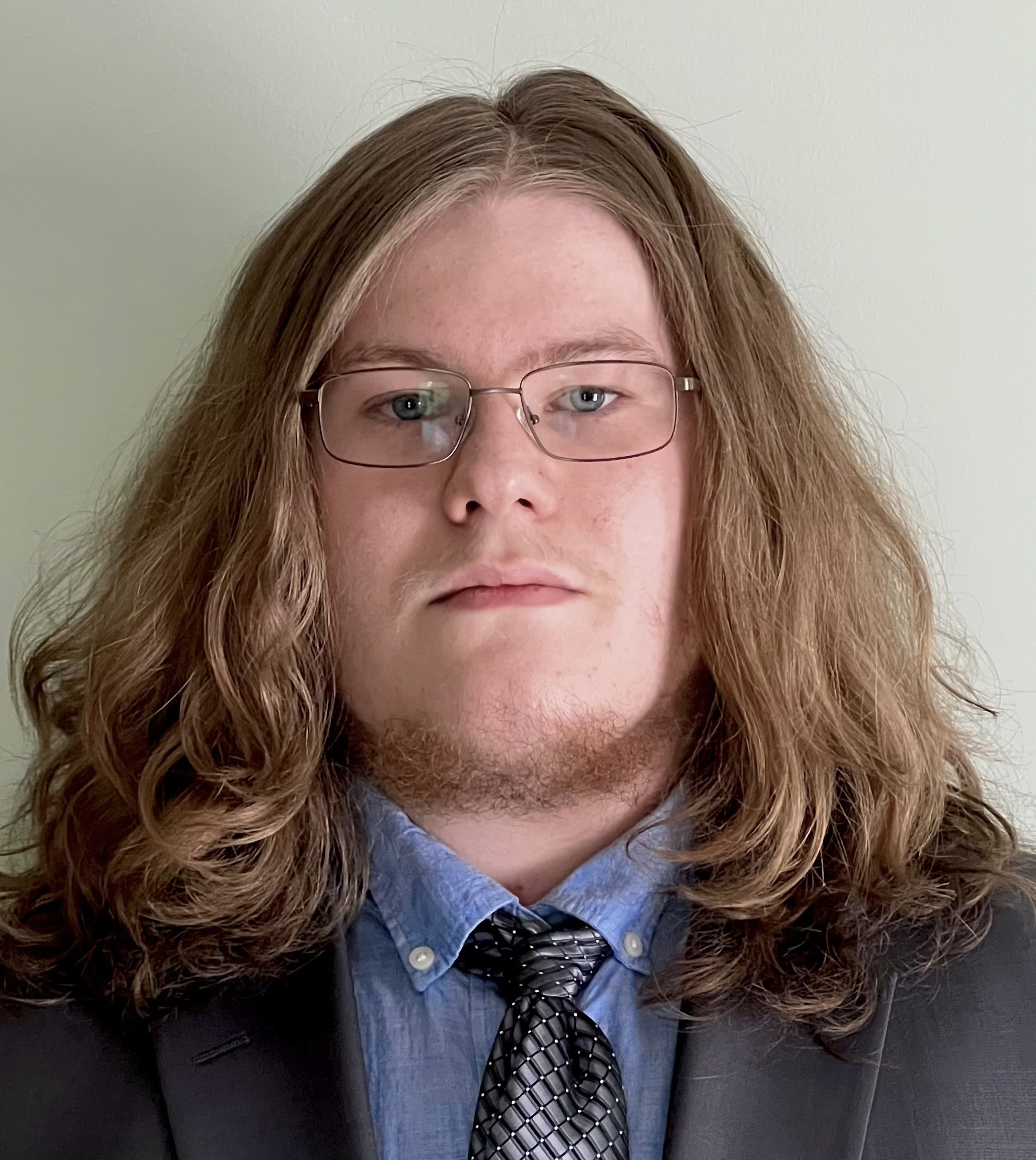 The image is a man's headshot.