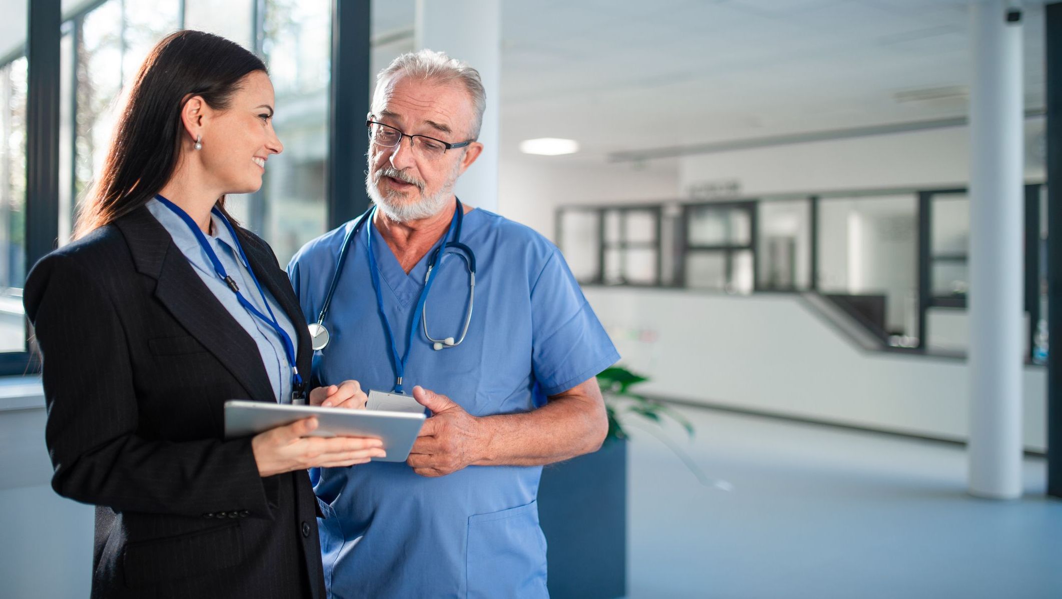 Doctor talks with a healthcare administrator in a hospital setting