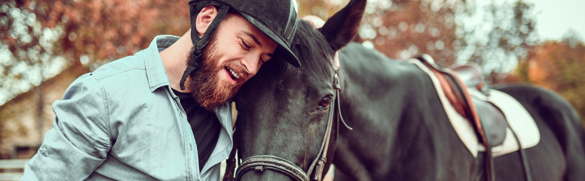 man standing next to horse