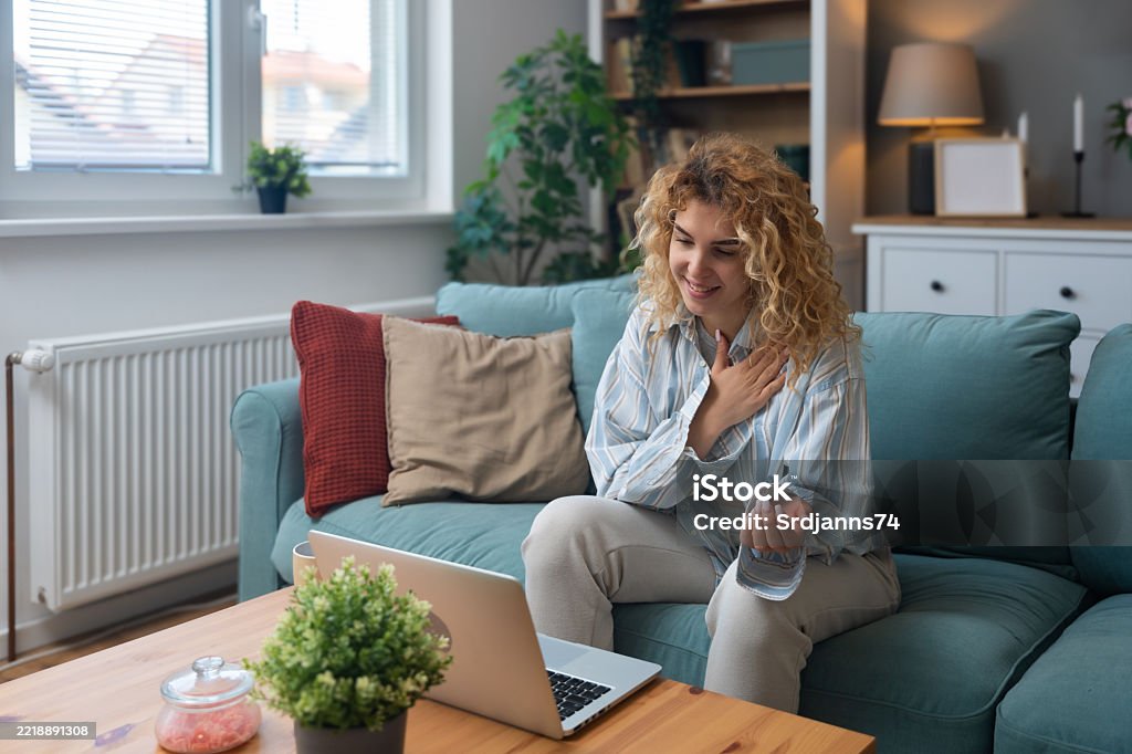 Young woman using a laptop to participate in a remote therapy session