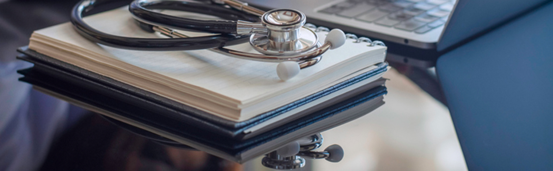 Stethoscope laying on a notebook