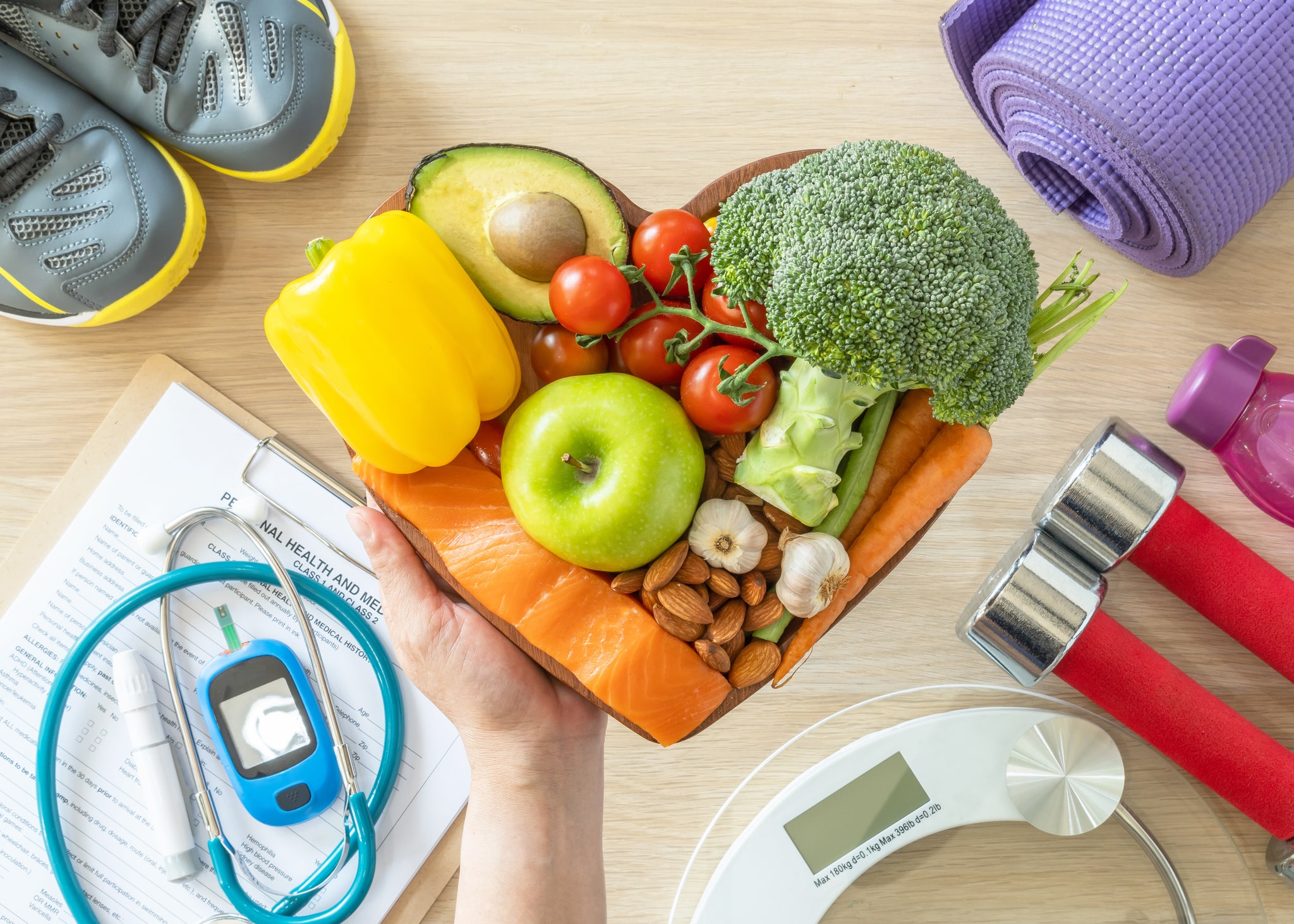 Table covered in health food, exercise equipment and medical tools.