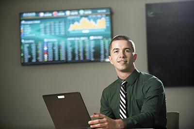 student sitting at a desk with a laptop computer