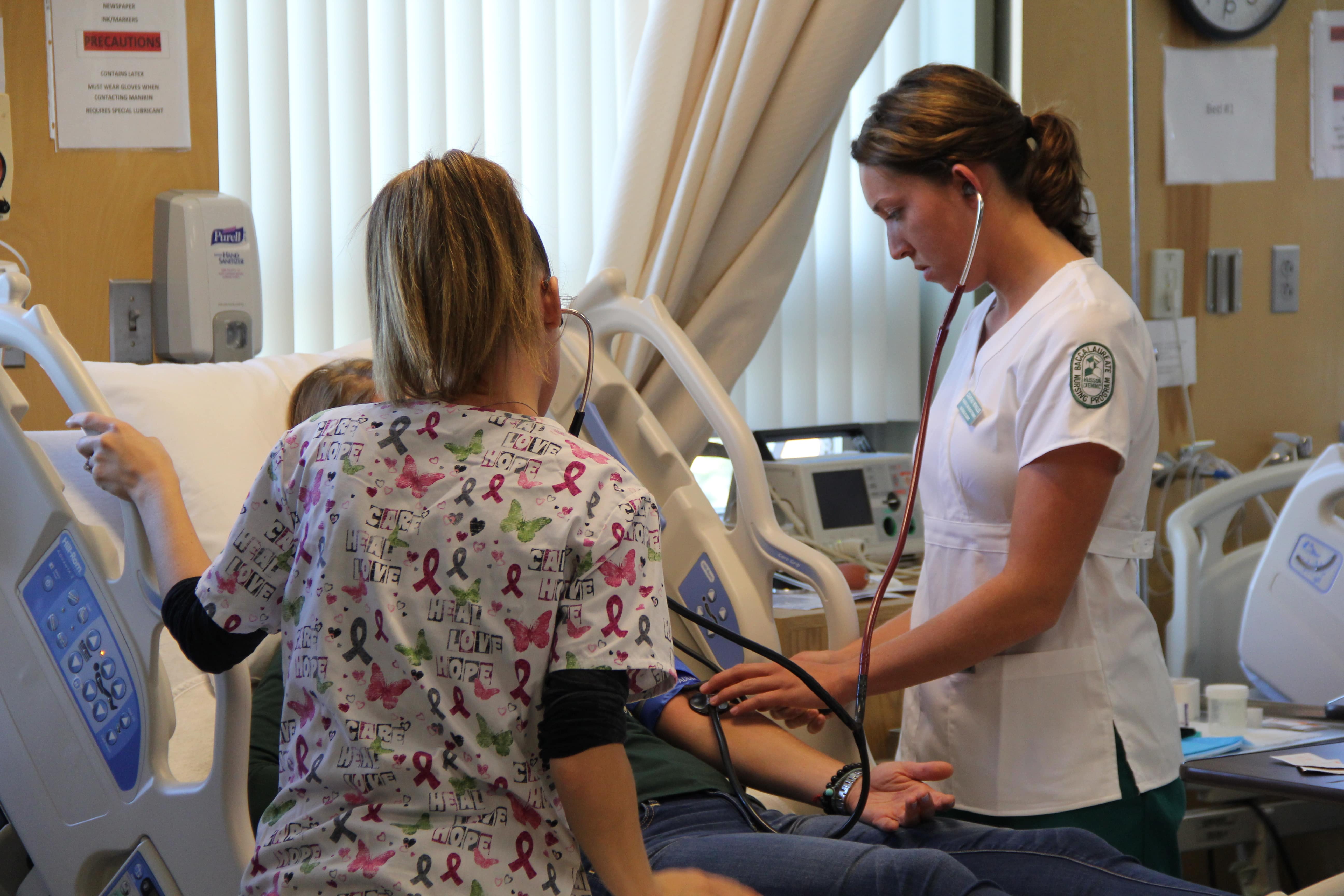 Nursing student attending to a patient.
