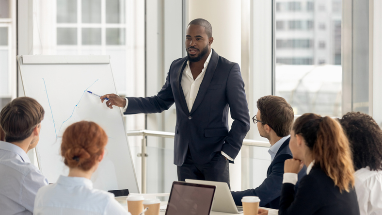 a business executive giving a presentation to a group of people