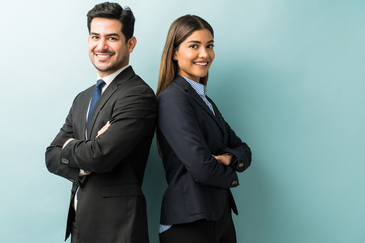 business man and business woman standing back to back