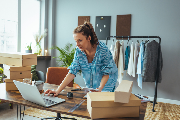 Woman working on laptop in office.