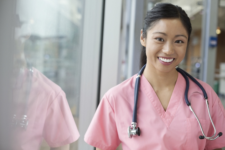 Smiling female nurse wearing pink scrubs