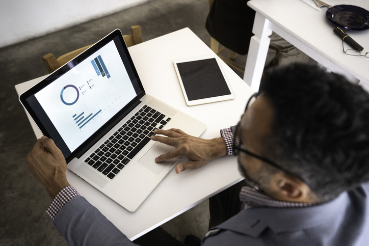 Male businessman viewing a chart on his laptop.