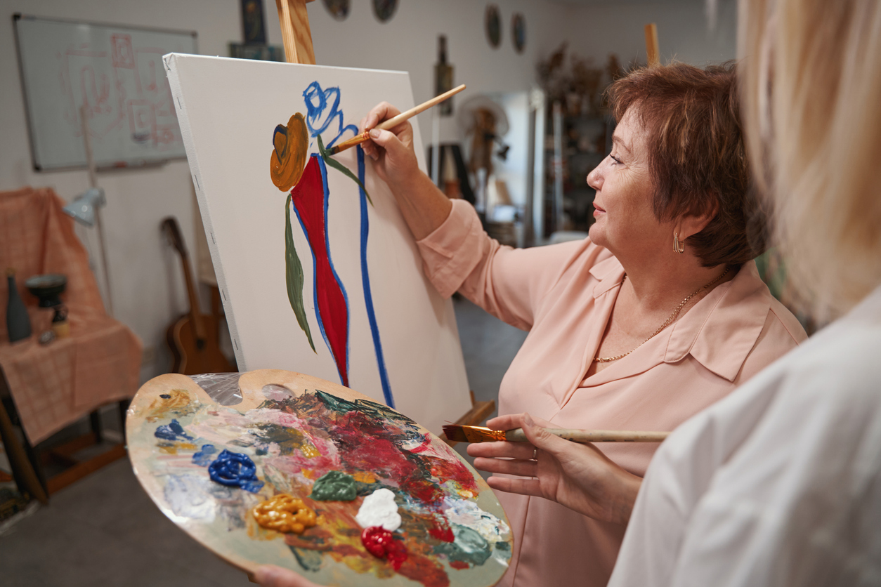 Woman painting on a canvas.