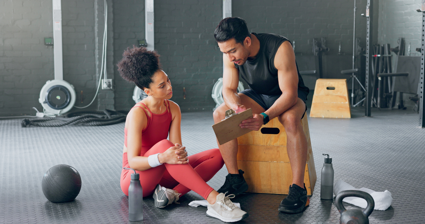 Male fitness instructor teaching a client.