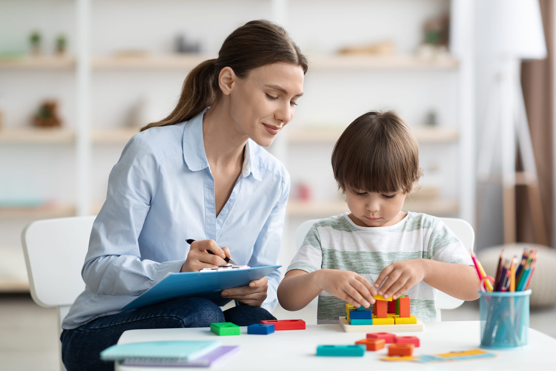 Counselor observes a child playing with blocks during a counseling session.