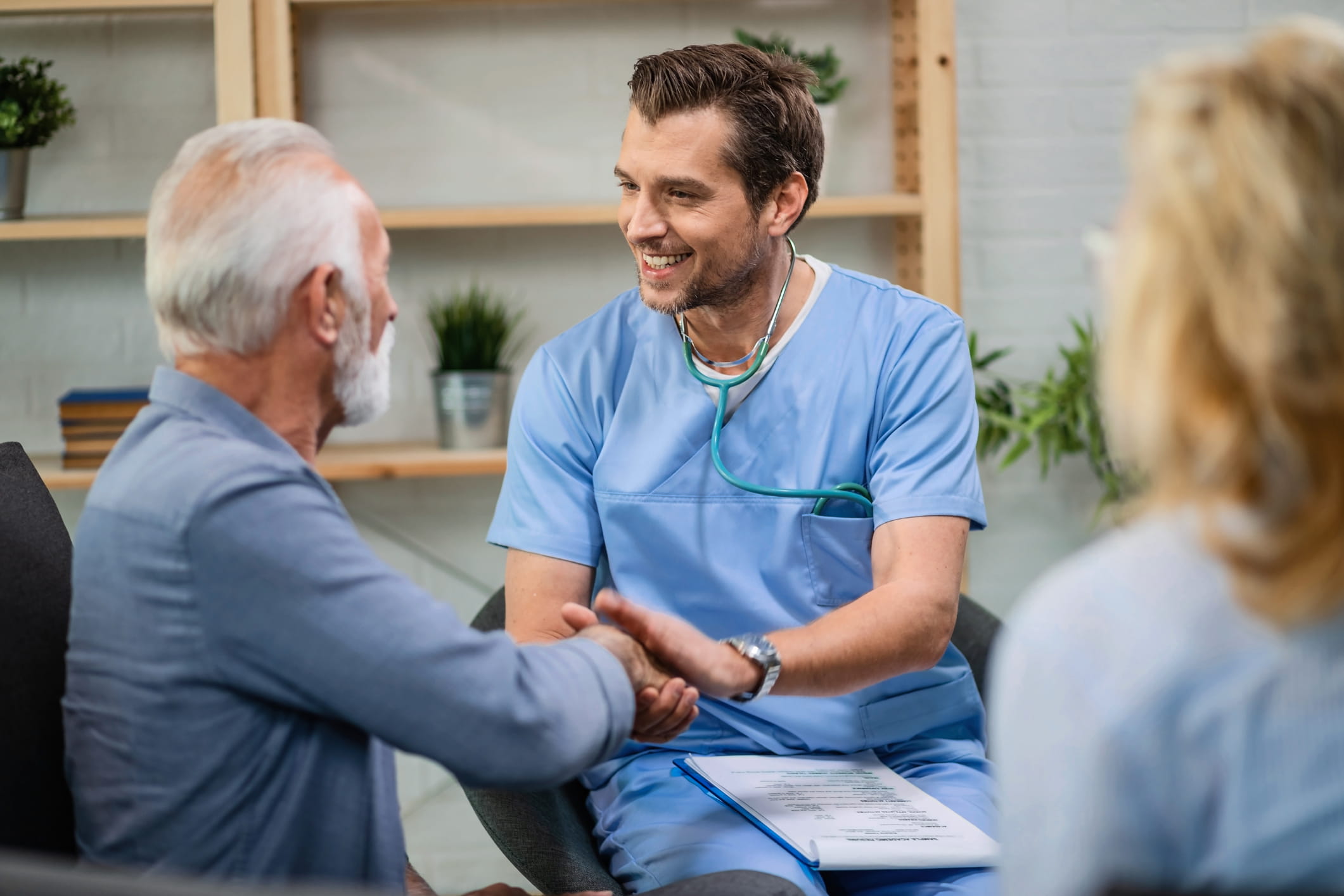   Search by image or video Happy healthcare worker and mature patient handshaking during a home visit.