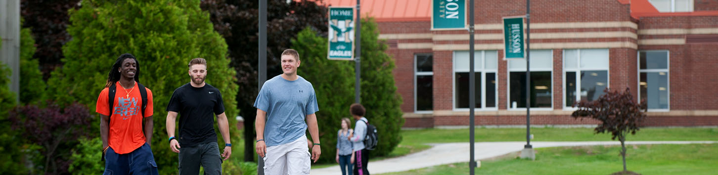 Students walking on campus of Husson University