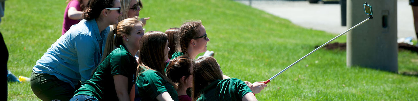 Students talking picture on campus of Husson University