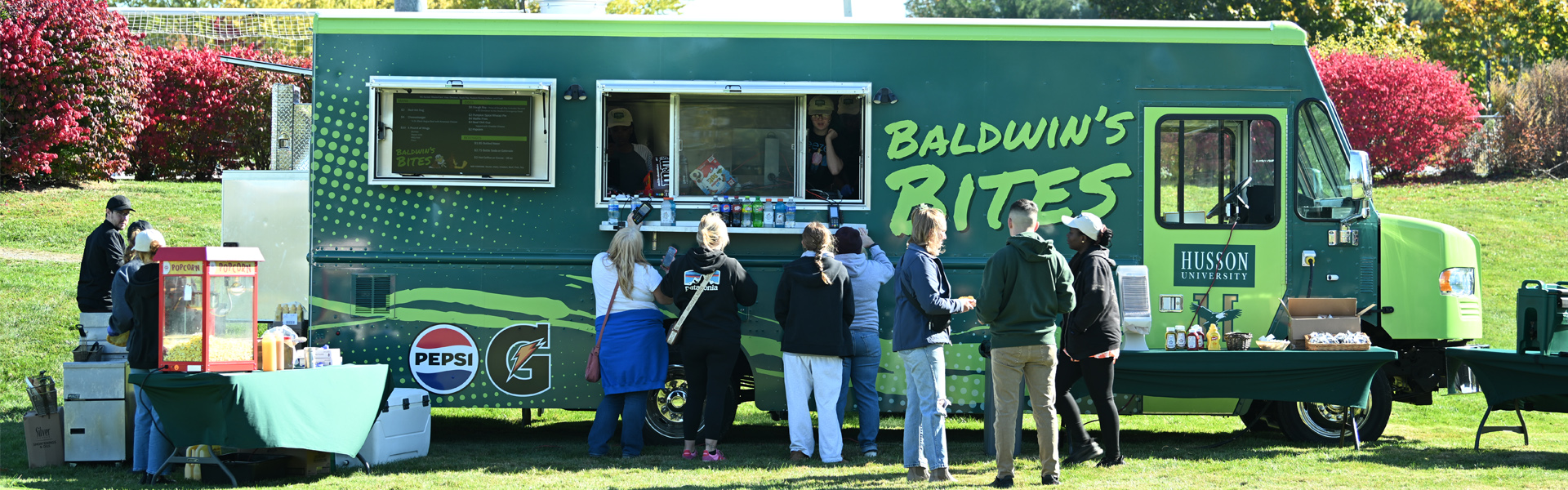 The Baldwin's Bites food truck at homecoming with patrons eating outside