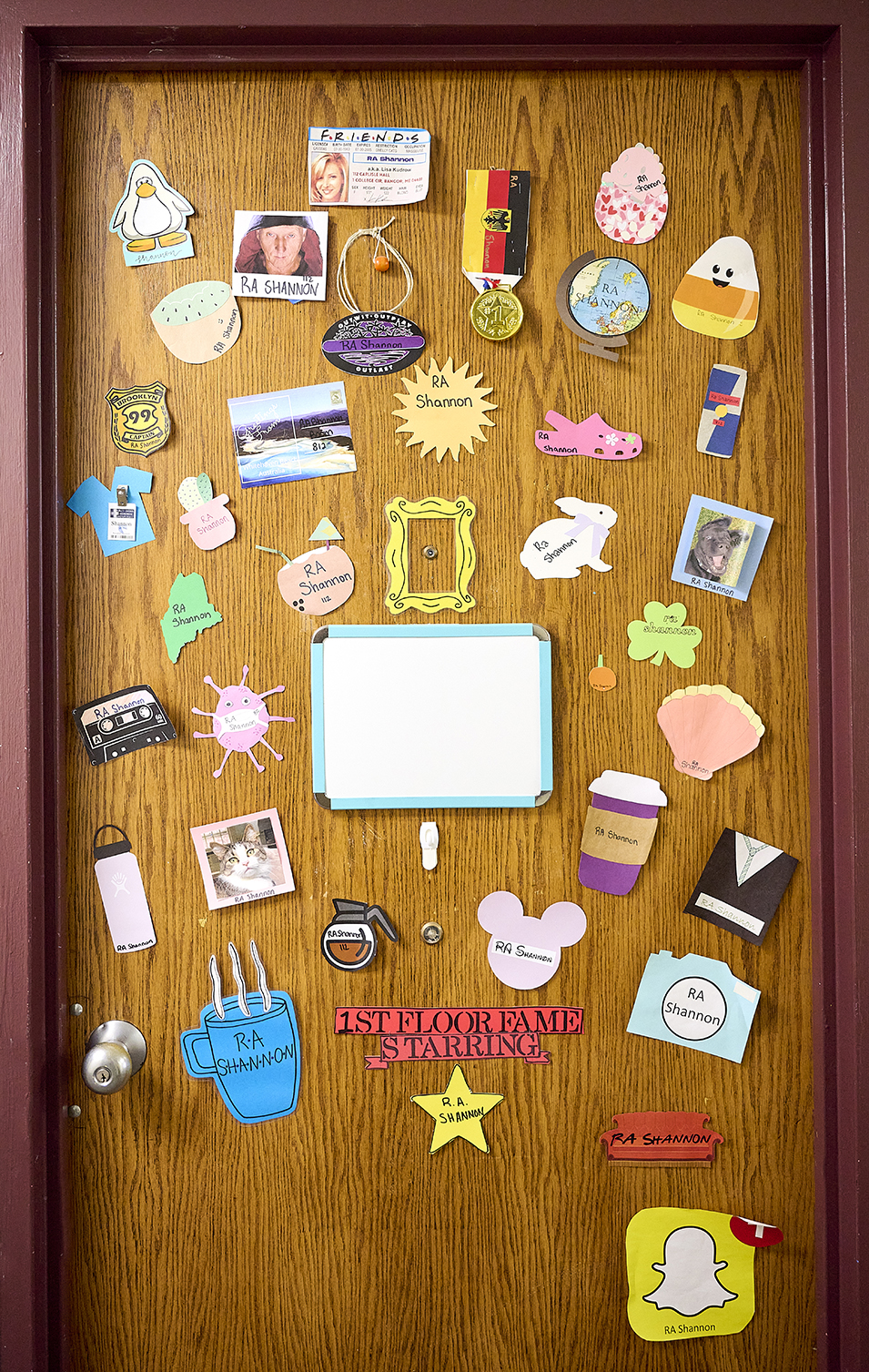A resident hall door is decorated with pictures and messages